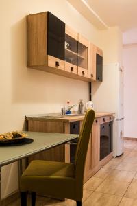 a kitchen with a table and a refrigerator at Apartament Ultracentral, Piata Romana in Bucharest