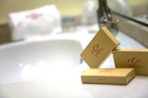 two boxes sitting on top of a bathroom counter at San Francesco Hotel in Loreto