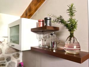a shelf with a vase and glasses on a wall at HealthyStudio512 Apartments in Kotor +126 photos