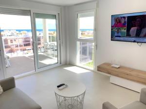 A television and/or entertainment centre at Beautiful apartment with pool near the beach