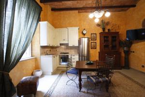 a kitchen with a table and chairs and a refrigerator at Casa Vacanza Colosseo in Rome