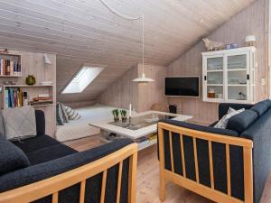 a living room with a couch and a table at 6 person holiday home in Ulfborg in Ulfborg