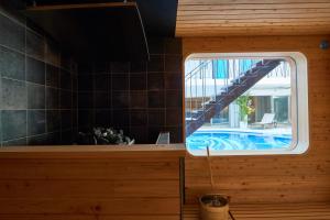 a kitchen with a window and a swimming pool at 8HOTEL Chigasaki in Chigasaki