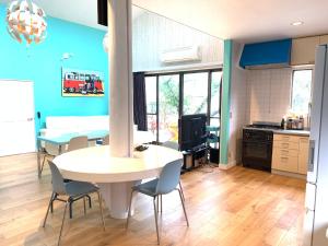 a kitchen and dining room with a table and chairs at Kisami Waves Beach House Shimoda in Shimoda +12 photos