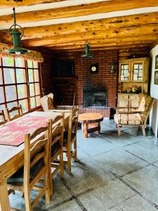 uma sala de jantar com uma mesa e uma lareira em Cabaña en la costa del Lago Futalaufquen - Parque Nacional Los Alerces em Esquel