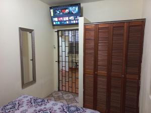 a bedroom with a bed and a mirror and a television at More Than Beauty Properties in San Juan