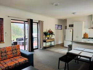 a living room with a couch and a kitchen at Warren Retreat - cozy and tranquil 2 brm home in Nannup