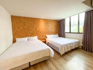 Una cama o camas en una habitación de Light Hostel - Tainan