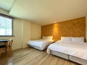 Una cama o camas en una habitación de Light Hostel - Tainan
