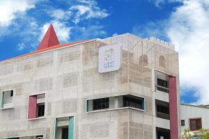 a building with a sign on top of it at Light Hostel - Tainan in Tainan