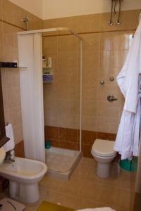 a bathroom with a shower and a toilet and a sink at I Giardini di San Vito lo Capo in San Vito lo Capo