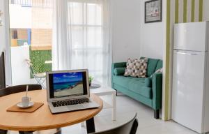 a kitchen with a table with a laptop on it at Casa Frida with High-speed Wifi and Smart-TV in Corralejo