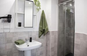 a white bathroom with a sink and a shower at Casa Frida with High-speed Wifi and Smart-TV in Corralejo +22 photos