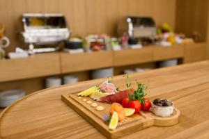 a tray of fruits and vegetables on a table at Hotel Bono in Budva