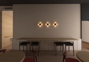 a bar with chairs and lights on a wall at Hotel Bono in Budva