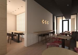a restaurant with tables and chairs and windows at Hotel Bono in Budva