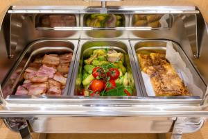 a refrigerator filled with different types of food at Hotel Bono in Budva