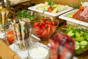 a table topped with bowls of vegetables and other appetizers at Hotel Bono in Budva