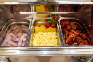 a lunch box filled with different types of food at Hotel Bono in Budva