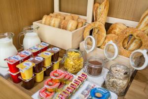a table with various types of bread and other foods at Hotel Bono in Budva
