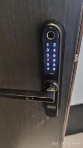 a close up of a microwave with a remote control at HaPPy Inn Rich Studio, Self Check-In-24x7,Parking-in-the-underground-Garage in Vilnius