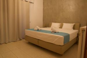 a bedroom with a bed with towels on it at Grand House in Agios Nikolaos