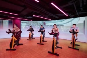 a group of people riding on an exercise bike at PARKROYAL COLLECTION Marina Bay, Singapore in Singapore