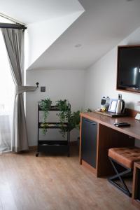 A television and/or entertainment centre at La Farine Rooms