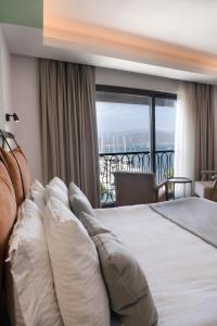 a bedroom with a bed with a view of the ocean at La Farine Hotel in Fethiye