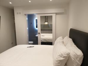 a bedroom with a white bed and a mirror at The Annex in Bristol