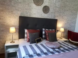 a bedroom with a large bed with two lamps at Casa Jetizo in Ontinyent