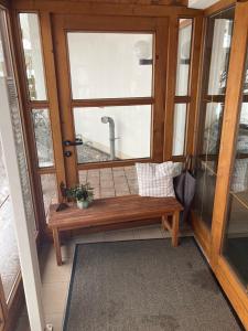 a room with a bench in front of a window at Bergsonnenblick Bad Hindelang in Bad Hindelang