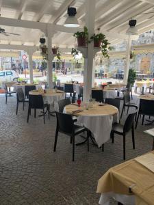 a restaurant with tables and chairs in a building at B&B Celestina Peschici in Peschici