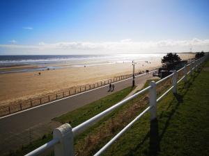 a view of a beach with people walking on it at 238b South shore in Bridlington