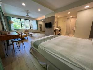a large bedroom with a large bed and a desk at Sea Passion Hotel in Koror