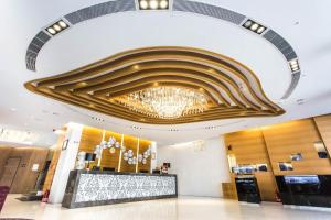 a lobby with a large chandelier hanging from the ceiling at Royal Fine Hotel in Kaohsiung