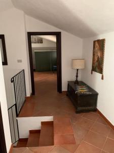 a hallway with a room with a table and a lamp at La dimora di Adelaide in Maratea