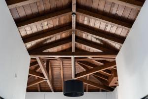 a wooden ceiling with a black light hanging from it at Jasmine by the sea - Κάτω Γατζέα, Πήλιο in Kato Gatzea +50 photos