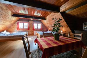 a dining room with a table and a bedroom in a cabin at Chalupa 409 in Rokytnice nad Jizerou