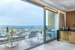 a kitchen and living room with a view of a marina at SAVUS Boutique Hotel in Rethymno Town