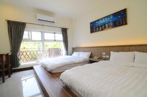 Krevet ili kreveti u jedinici u okviru objekta Xinghai Seaview Guesthouse
