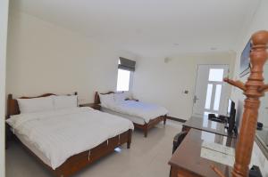 Krevet ili kreveti u jedinici u okviru objekta Xinghai Seaview Guesthouse