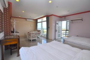 Krevet ili kreveti u jedinici u okviru objekta Xinghai Seaview Guesthouse