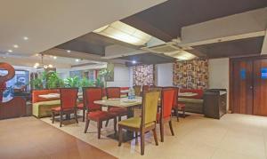 a dining room with a table and chairs at Treebo Tryst Dee Empresa in Kolkata