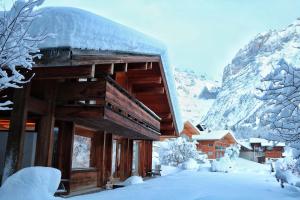 a log cabin with snow on the side of it at Chalet Morgane in Grindelwald