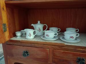 a cabinet with a bunch of cups and saucers on it at Nostalgie Bahnhof in Gmünd