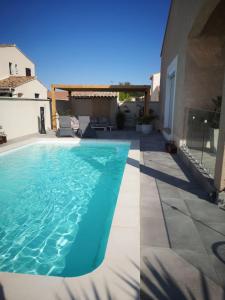 a swimming pool in the backyard of a house at les chambres du Saunier in Salin-de-Giraud