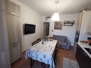 a kitchen with a table with a table cloth on it at The Royal House - un passo dalla reggia /en-es-it in Venaria Reale