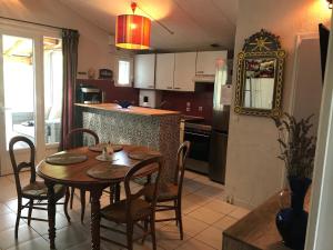 a kitchen and dining room with a table and chairs at Mas de la Vieille Vigne in Argelès-sur-Mer +10 photos