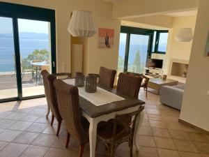 a dining room with a table and chairs at villa with great seaview in Ambelón